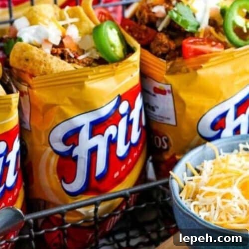 Frito bags filled with ground beef and taco toppings.