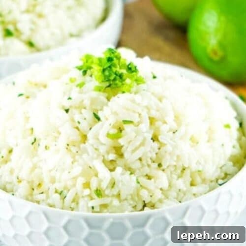 a bowl of rice with cilantro and lime juice.