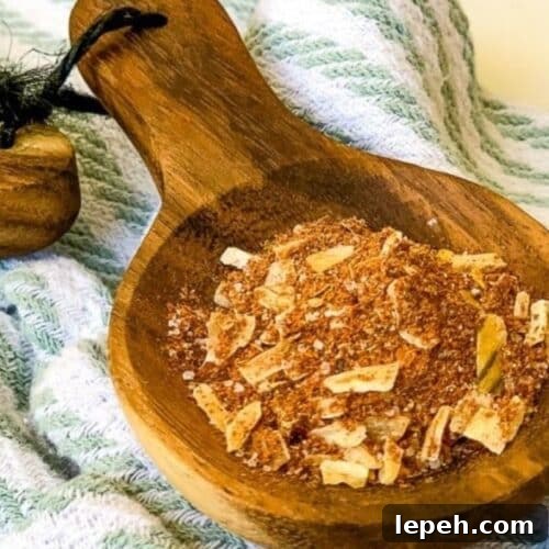 A wooden spoon of homemade chicken taco seasoning.