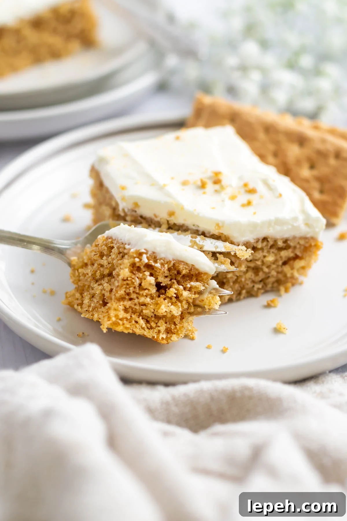 fork with a bite of graham cracker cake