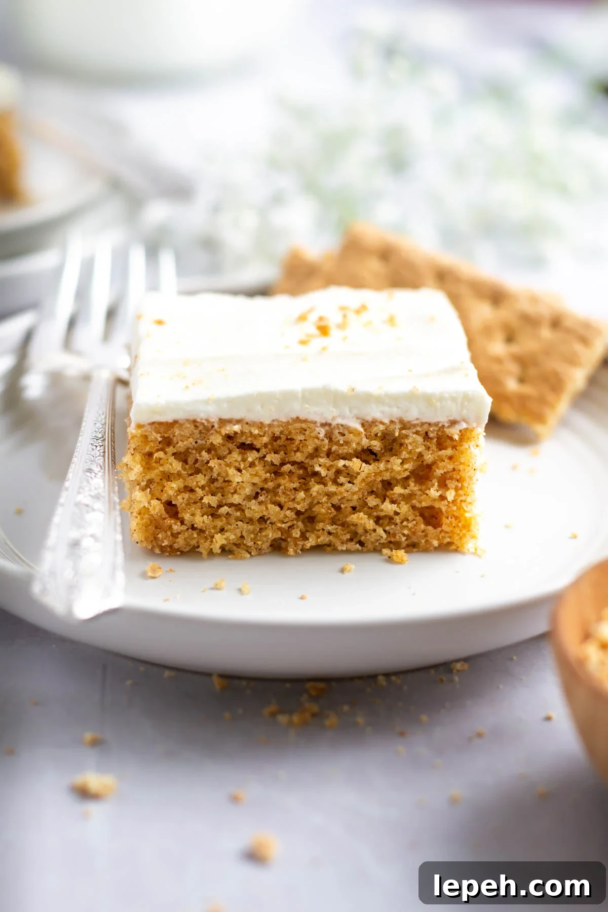 slice of graham cracker cake on a plate with a fork