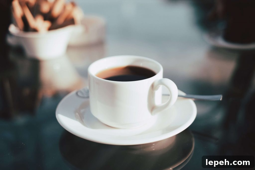 coffee cup on a table with a spoon on the saucer