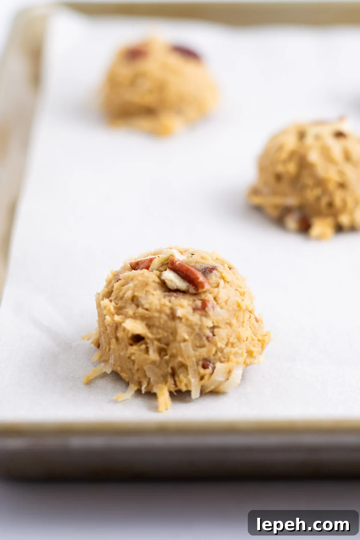 cookie dough balls on parchment lined baking sheet