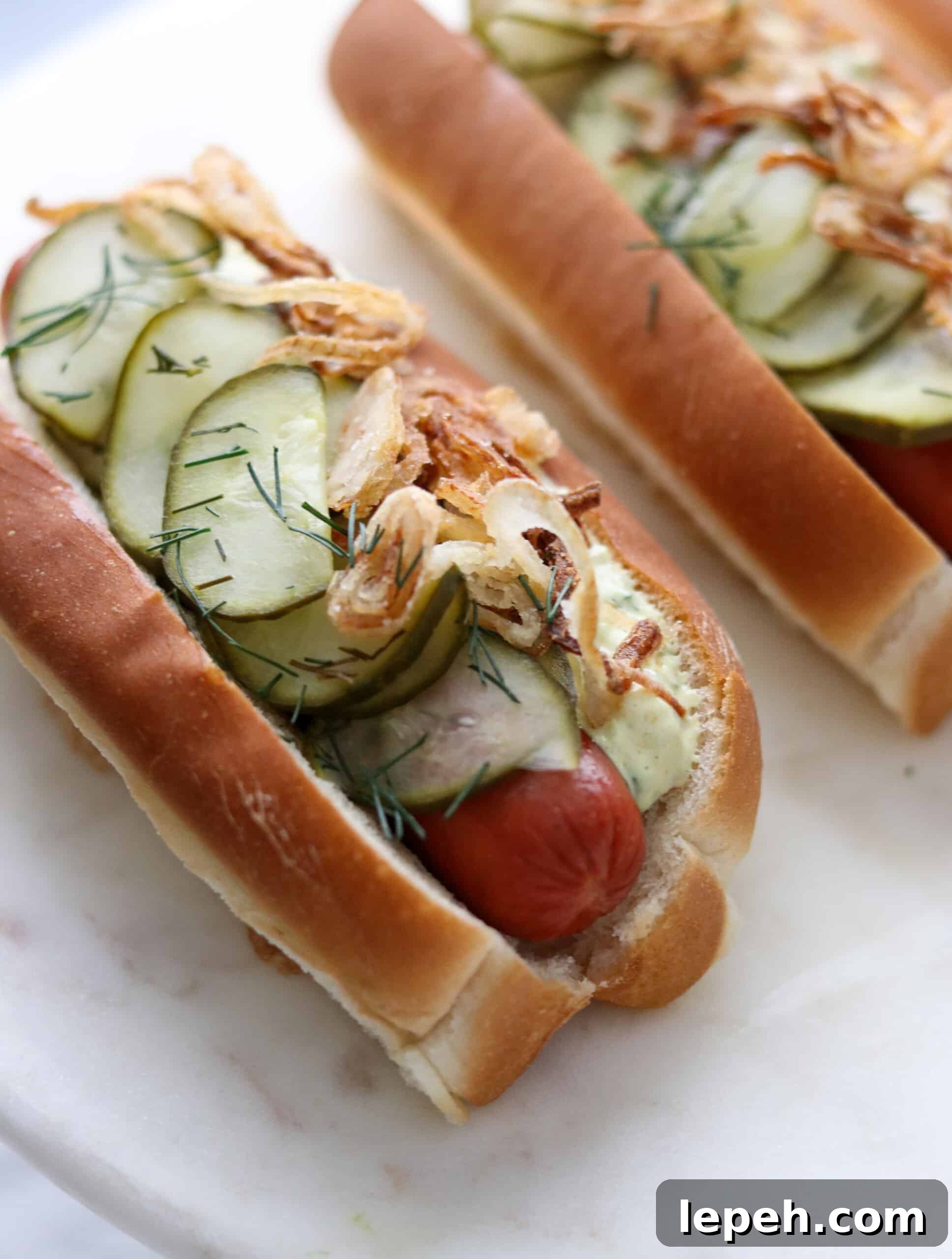Danish Hot Dogs on a marble surface.