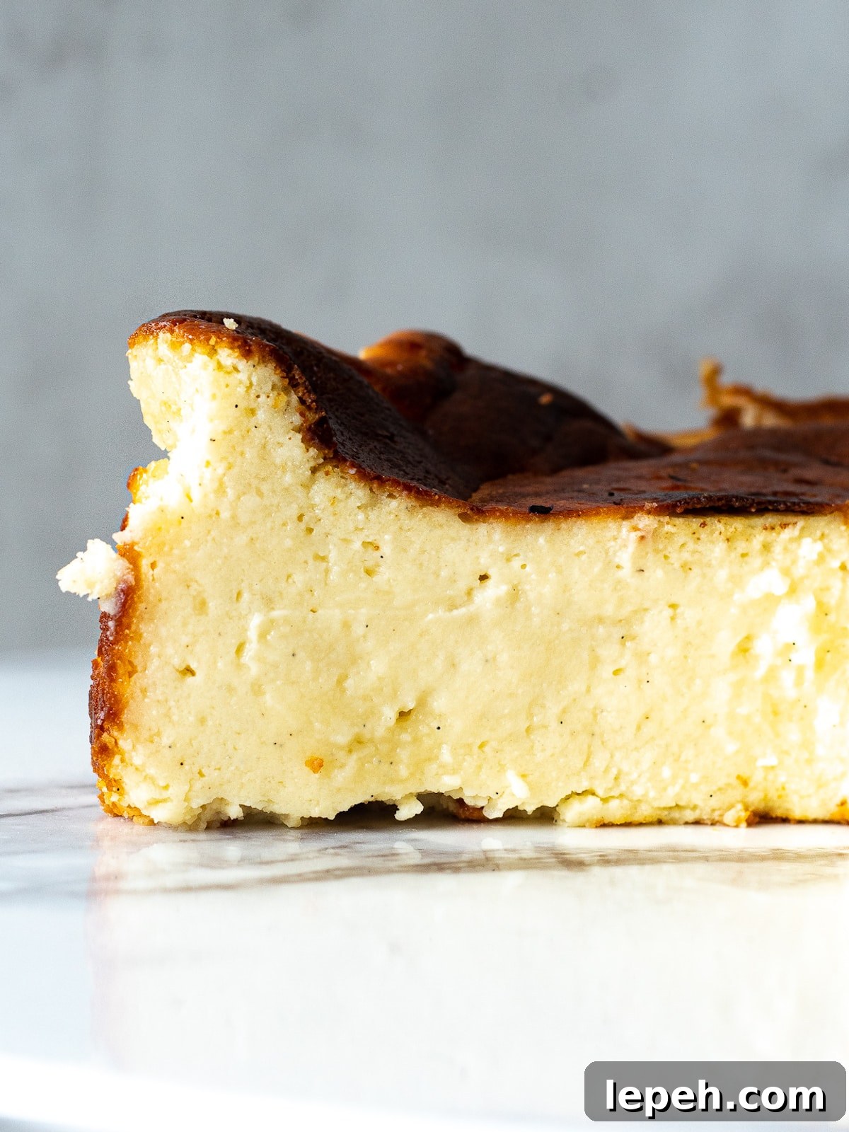 Side view of slice of mini basque cheesecake