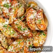 Parmesan truffle roasted fingerling potatoes in a white serving bowl.