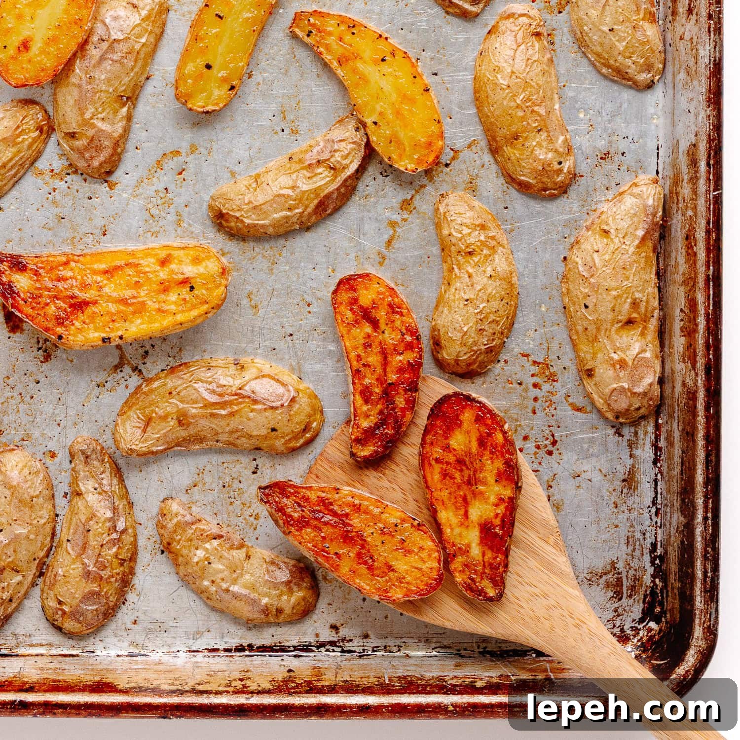 Roasted fingerling potatoes on a baking sheet.