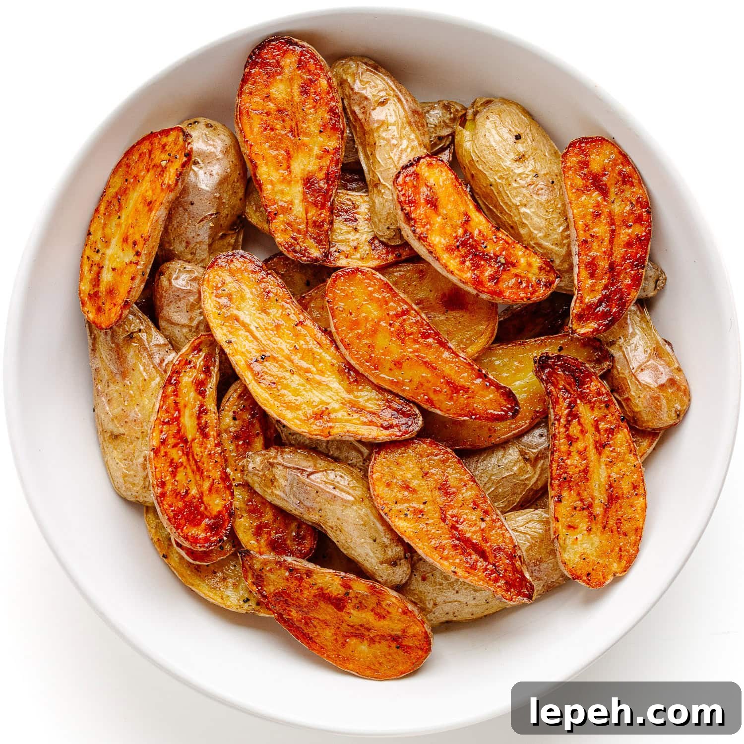 Truffle roasted fingerling potatoes in a white serving bowl.