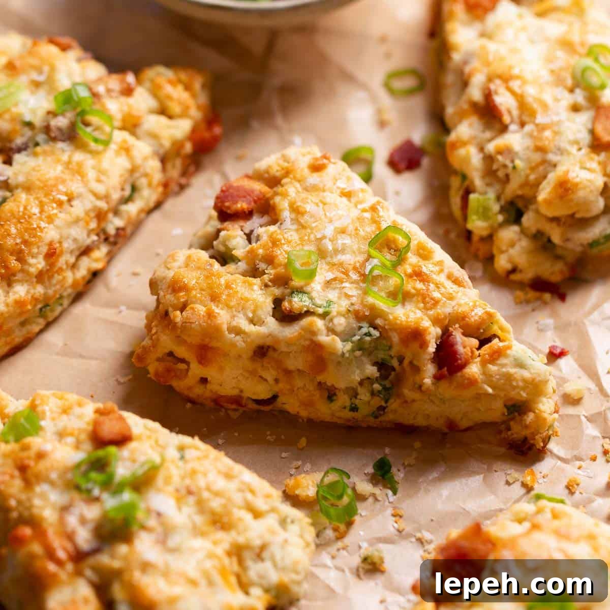 Savory bacon cheddar scones on parchment paper.
