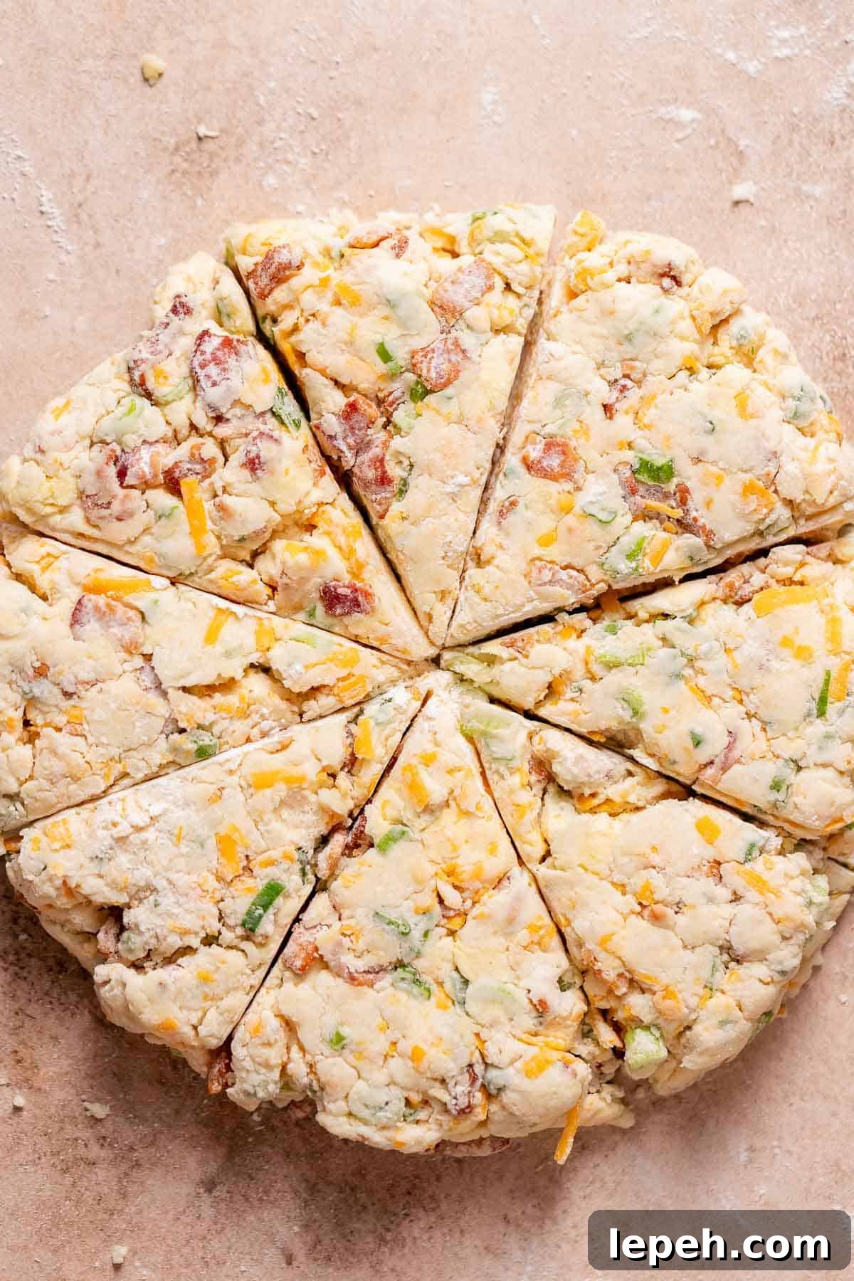 An overhead shot of the scone dough cut into 8 triangles.
