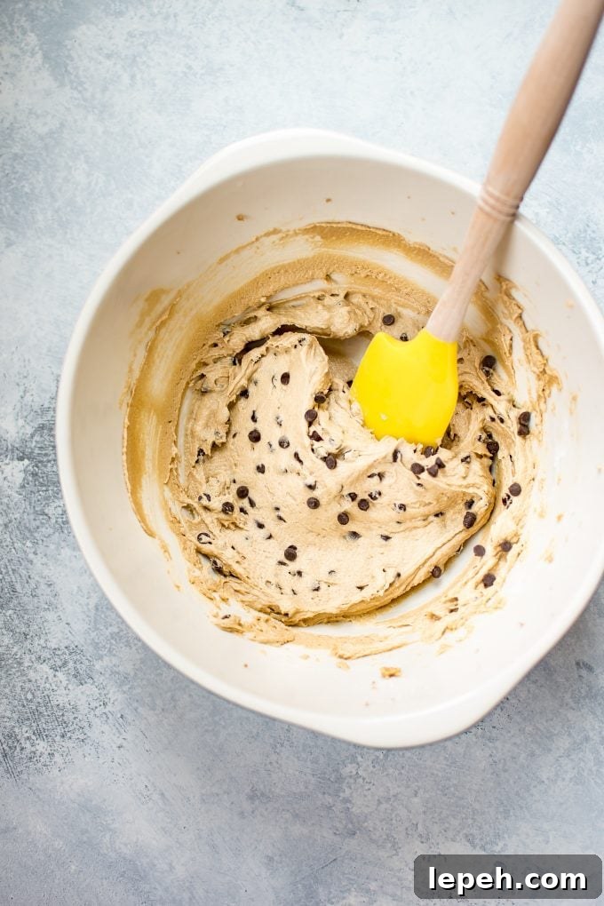 mixing bowl with vegan chocolate chip cookie dough frosting with spatula