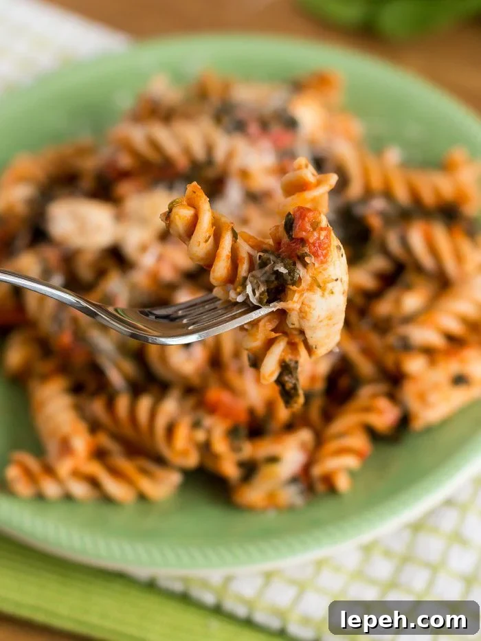 Easy Chicken with Pasta Dinner Recipe - Dress up your spaghetti with chicken, spinach, and a bit of spice!