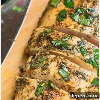 Easy Sliced Greek Chicken Breast on Wood Board.
