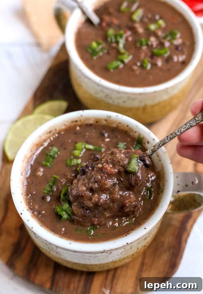 a bite being taken of gluten free black bean soup 