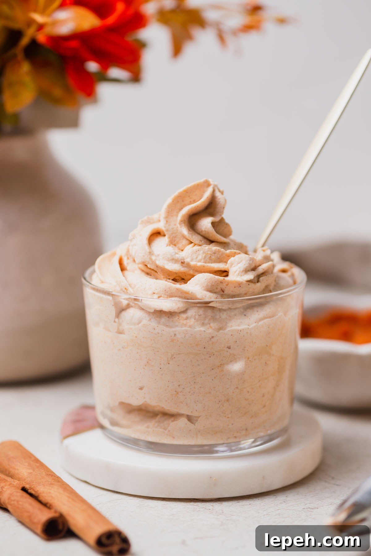 pumpkin whipped cream with a spoon in a jar.