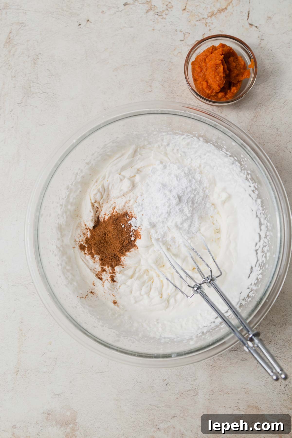 pumpkin whipped cream with pie spice and sugar in a bowl.