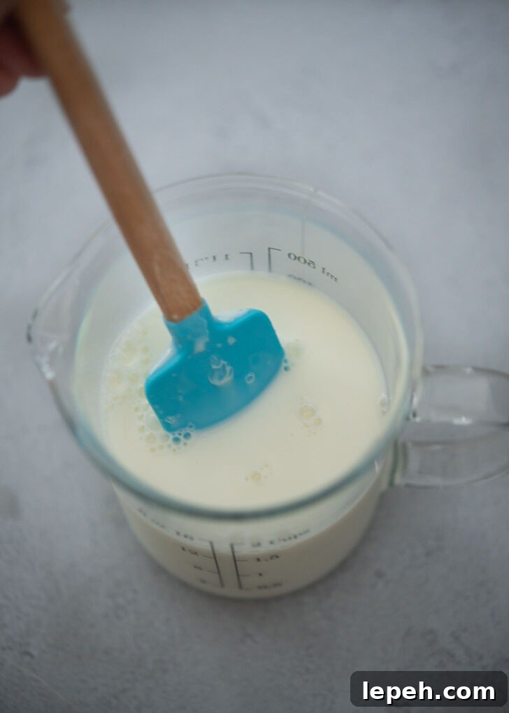 Milk mixture in a mixing cup to make milky shaved ice.