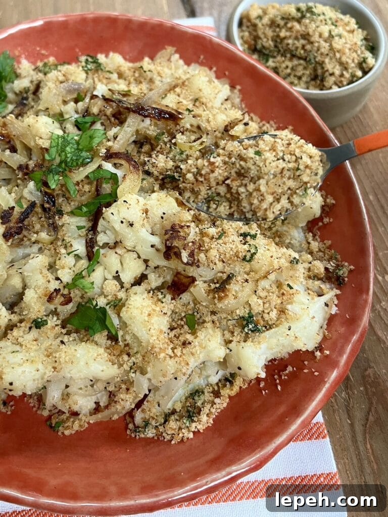 Sprinkling lemon herb breadcrumbs over smashed sauteed cauliflower, Italian-style.