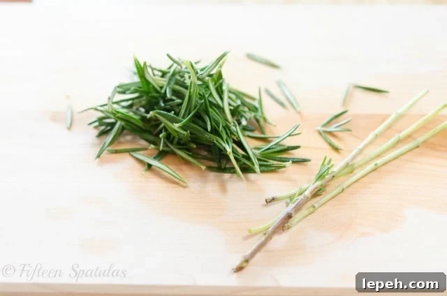 Stripped Fresh Rosemary Leaves on Cutting Board