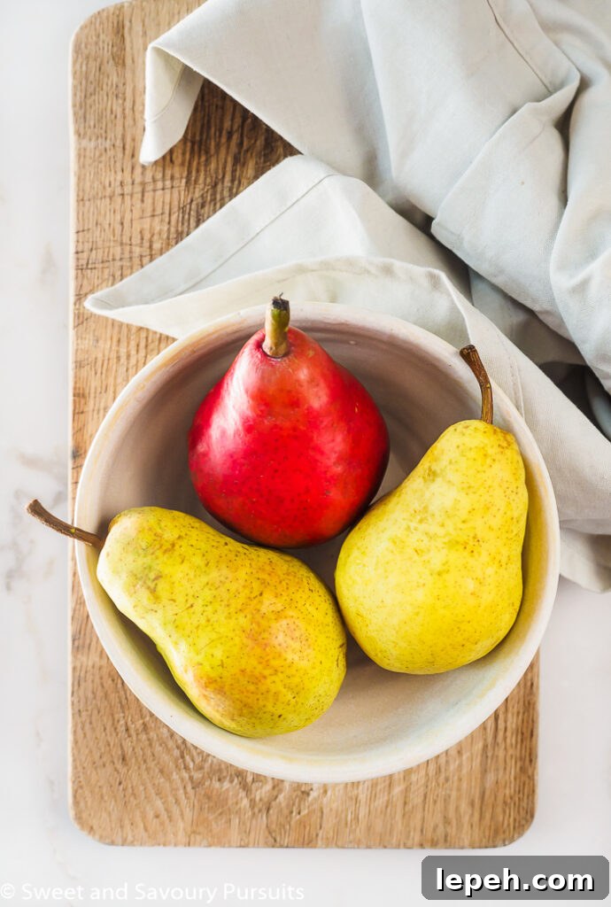 Bowl of one red and two yellow pears.