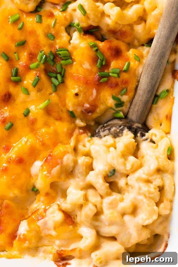 Spoon serving up homemade baked macaroni and cheese.