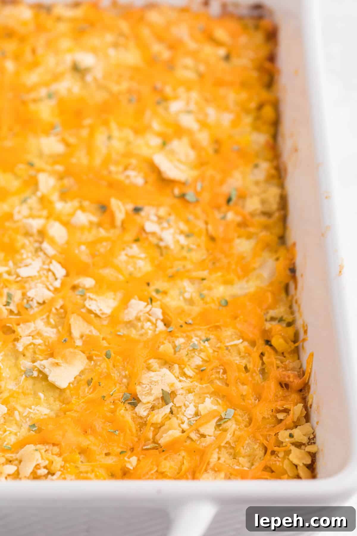 Cheesy corn casserole in a pan.