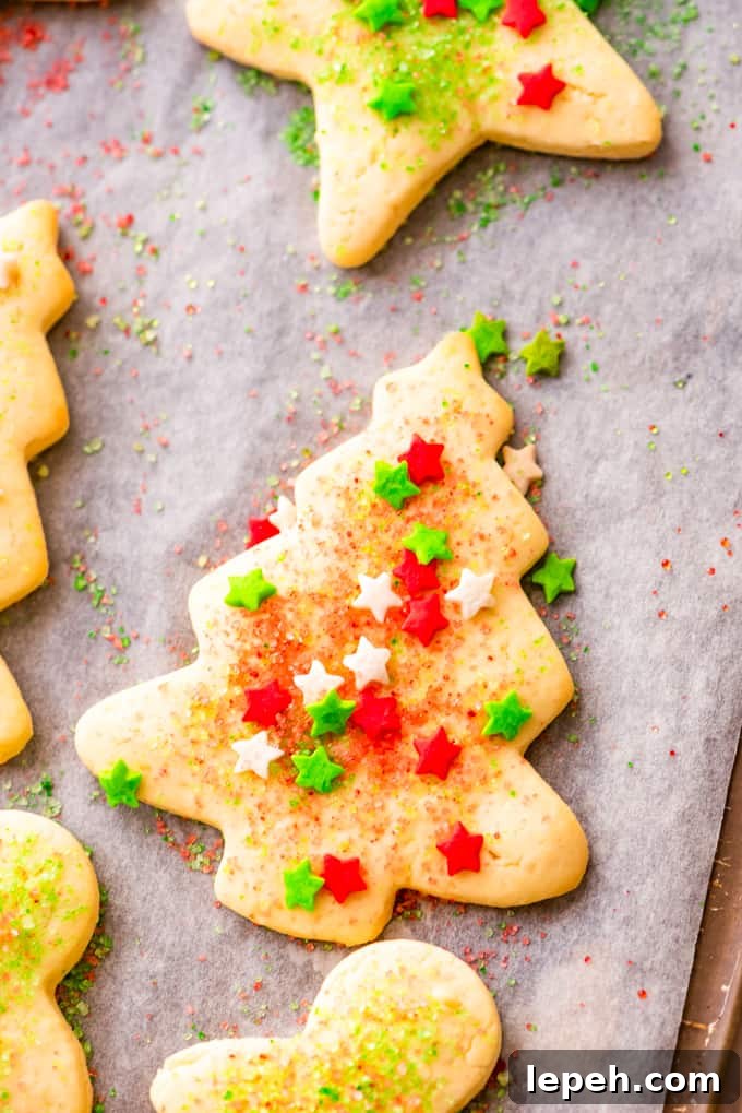 Sugar cookie with Christmas sprinkles on a baking sheet.