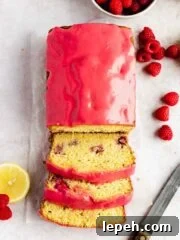 lemon raspberry loaf sliced with raspberry glaze on wax paper