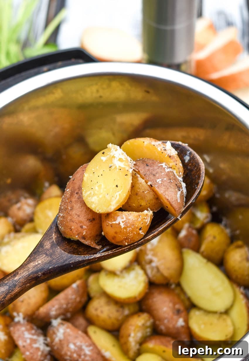 a wooden spoon holding up a scoop of instant pot italian potatoes