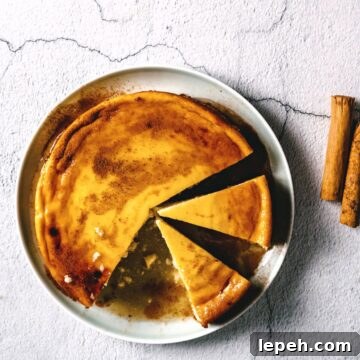 a greek cheesecake on a plate drizzled with honey.