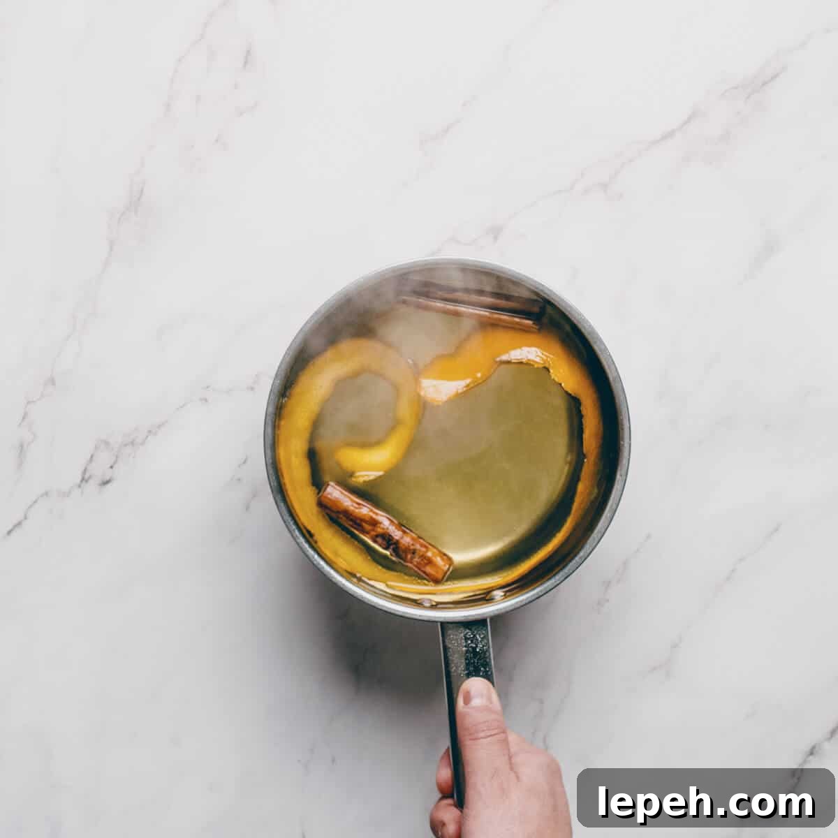 a pot filled with a sugar syrup flavoured with orange and cinnamon.