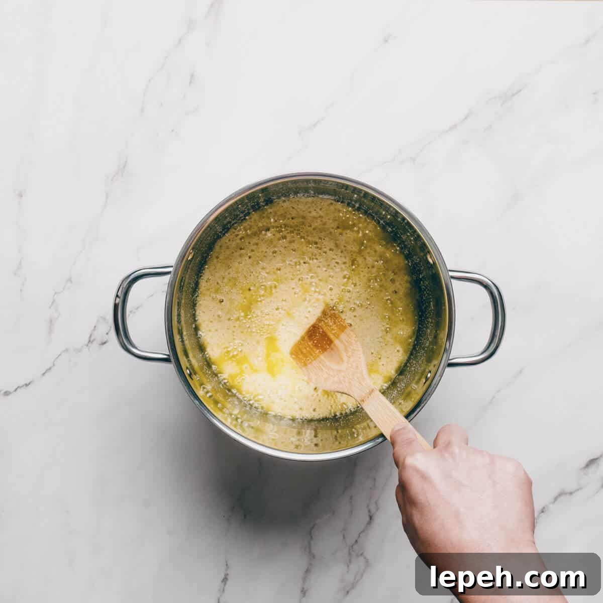 stirring semolina in a pot with oil to make halva.