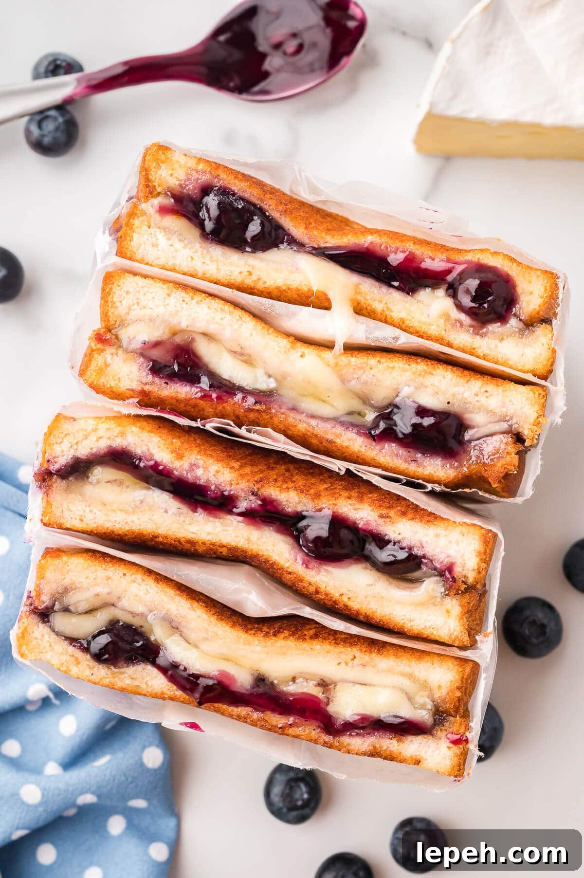 A blueberry brie grilled cheese wrapped in parchment paper.