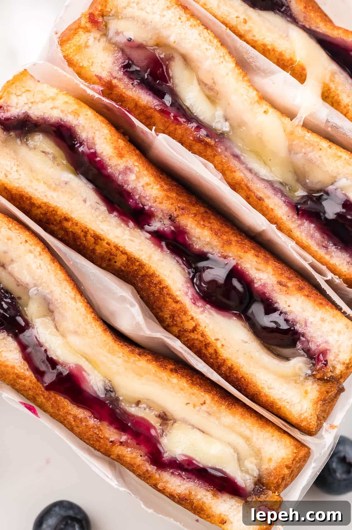 Close up of a blueberry brie grilled cheese sandwich.