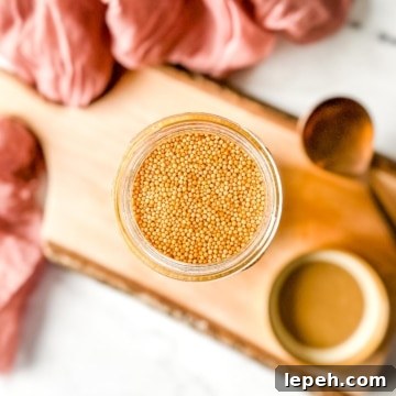 Pickled mustard seeds in a glass jar.