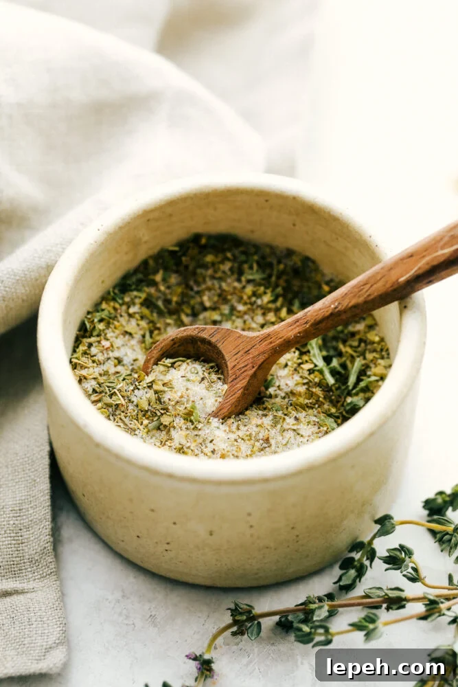 Italian dressing mix in a bowl with a tiny spoon.