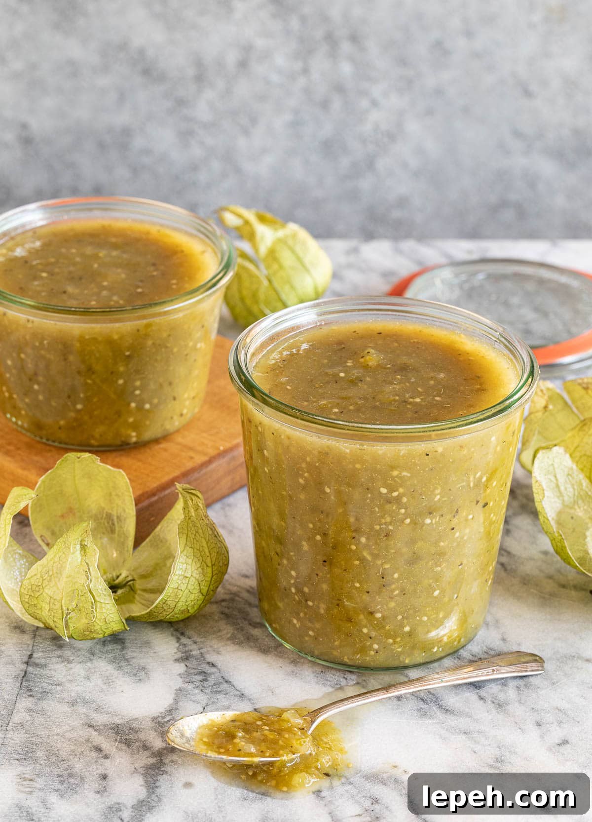 jars of freshly made tomatillo salsa verde (tomatillo sauce)  on a counter. 
