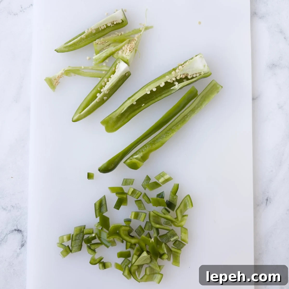 Chopping green chili pepper and deseeding them. 