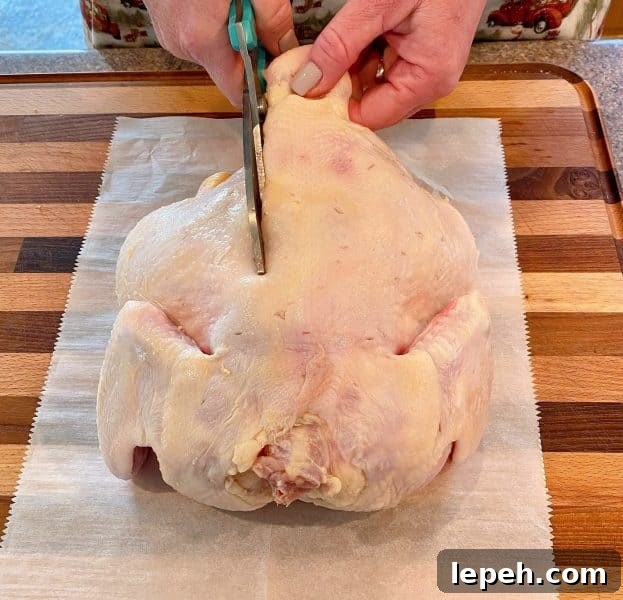 Cutting the back bone out of the chicken