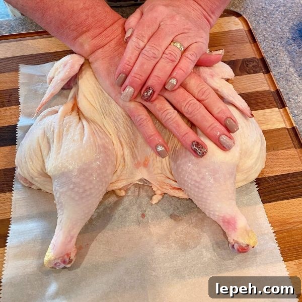 Flattening the chicken with palms
