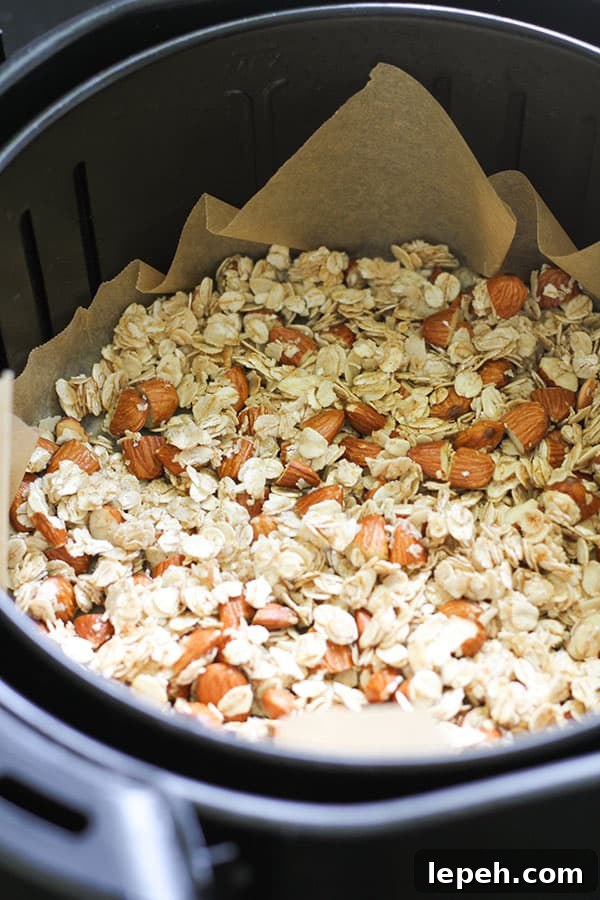 granola in an air fryer basket.