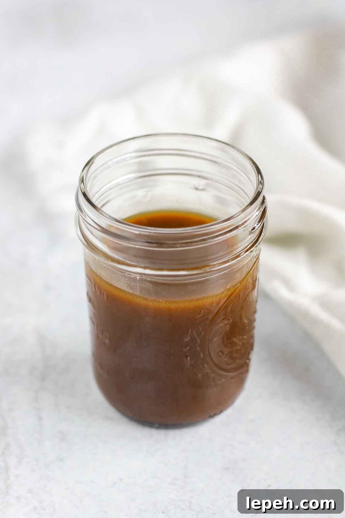 Mason jar filled with balsamic vinaigrette dressing.