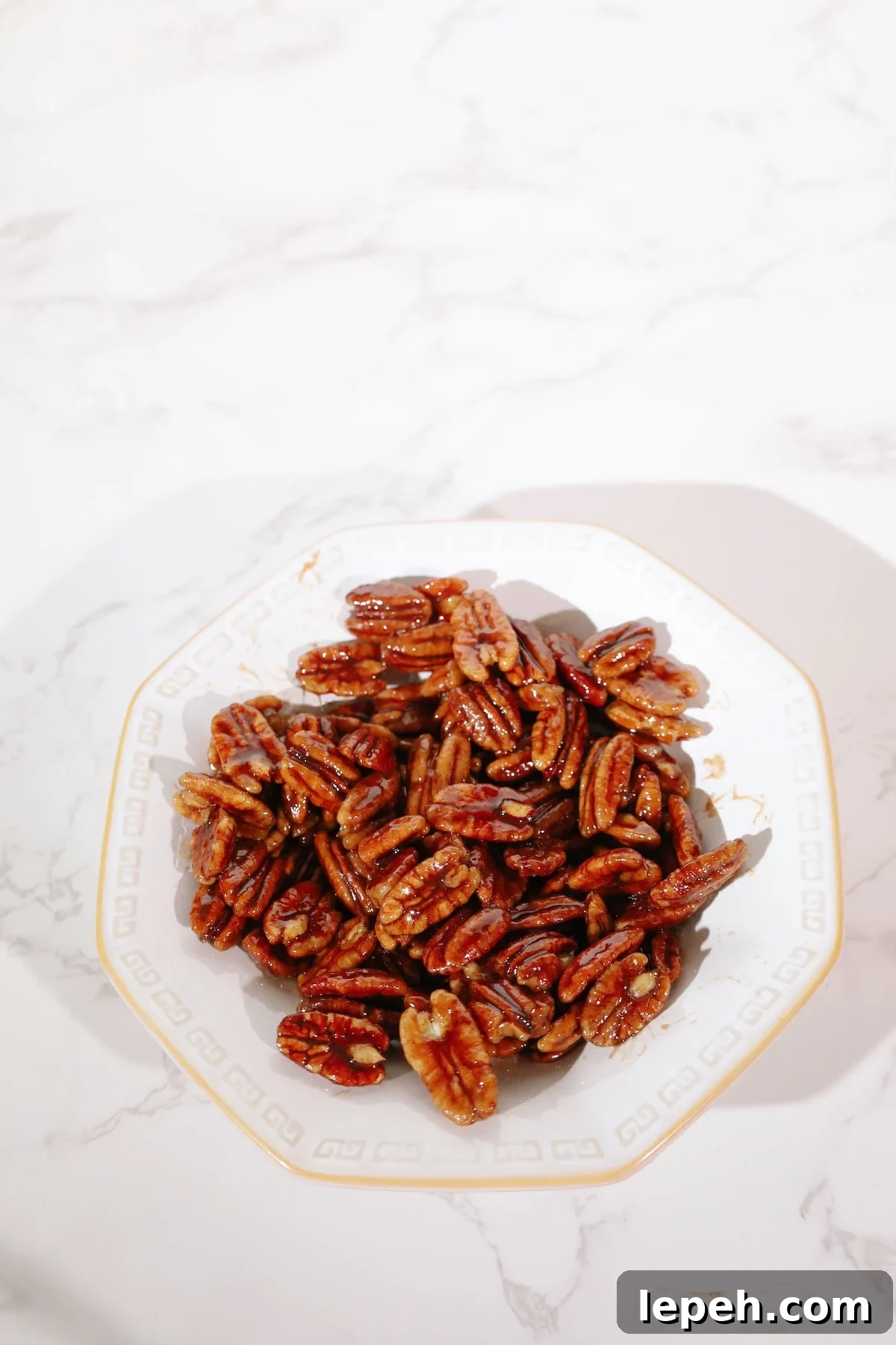 Candied pecans recipe on a plate.