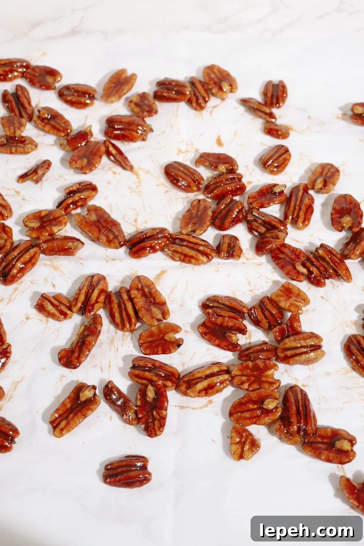 Step four: spread the candied pecans on parchment paper.