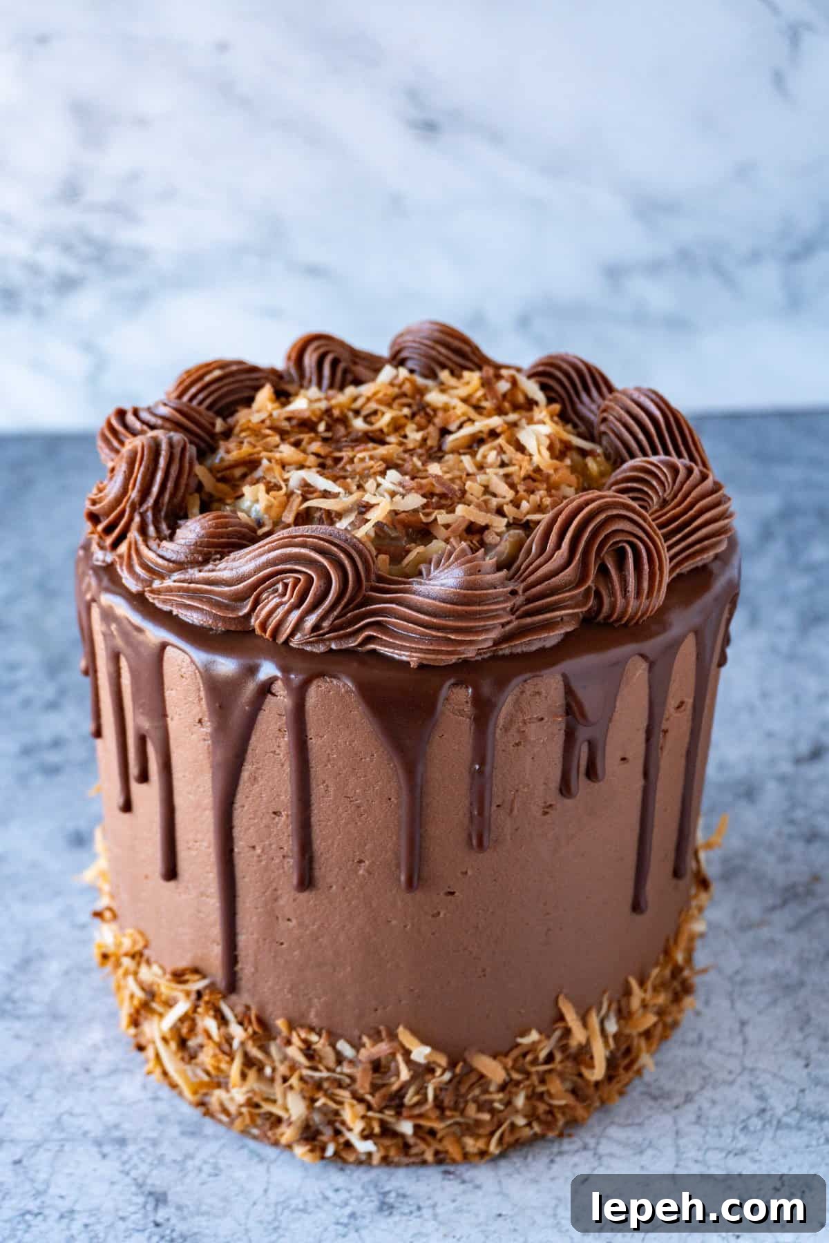 german chocolate cake with toasted coconut and chocolate drips.