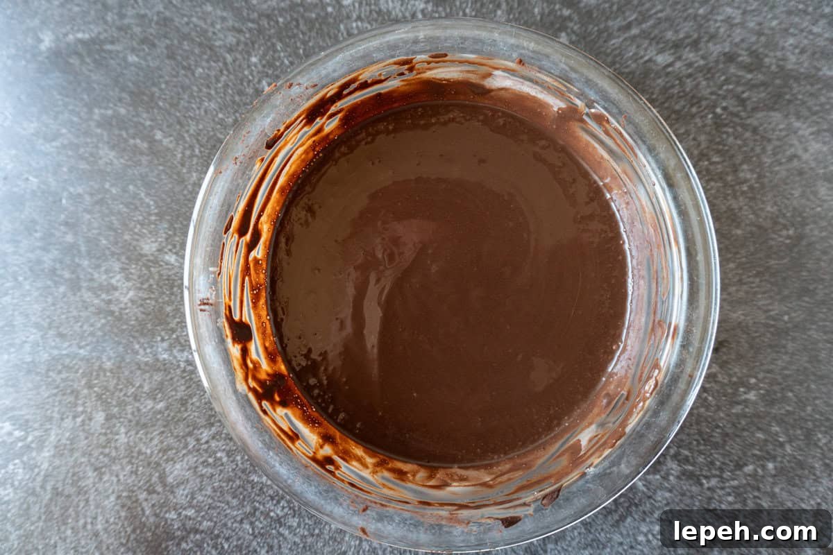 cocoa powder, buttermilk and vanilla mixed into a water/espresso mixture in glass bowl.