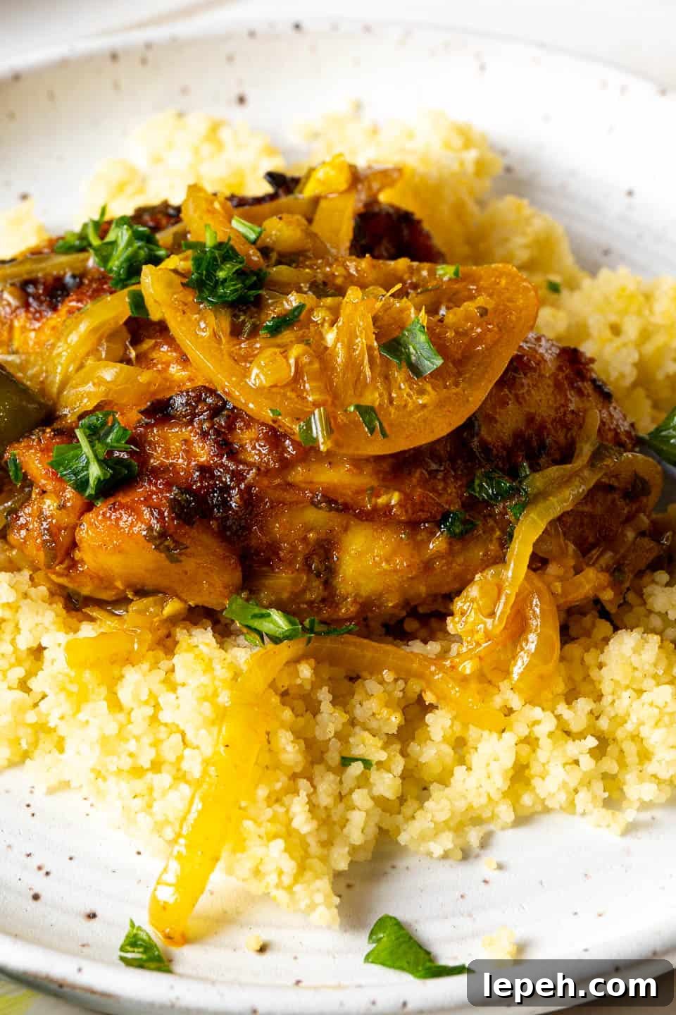 Moroccan chicken tajine over a plate of couscous