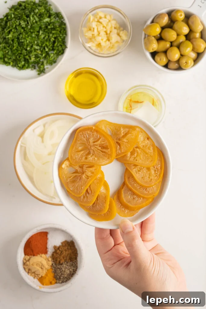 a hand holding a plate of preserved lemons