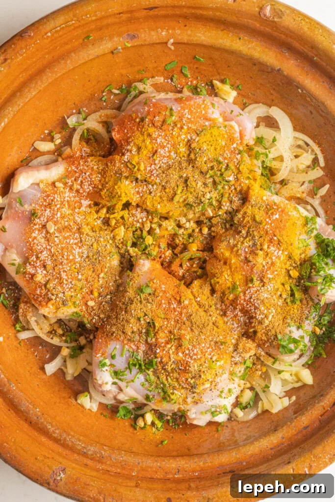 raw chicken with spices in a tagine