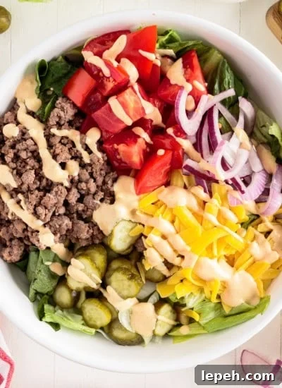 Top view of Big Mac Salad with dressing drizzled on top.
